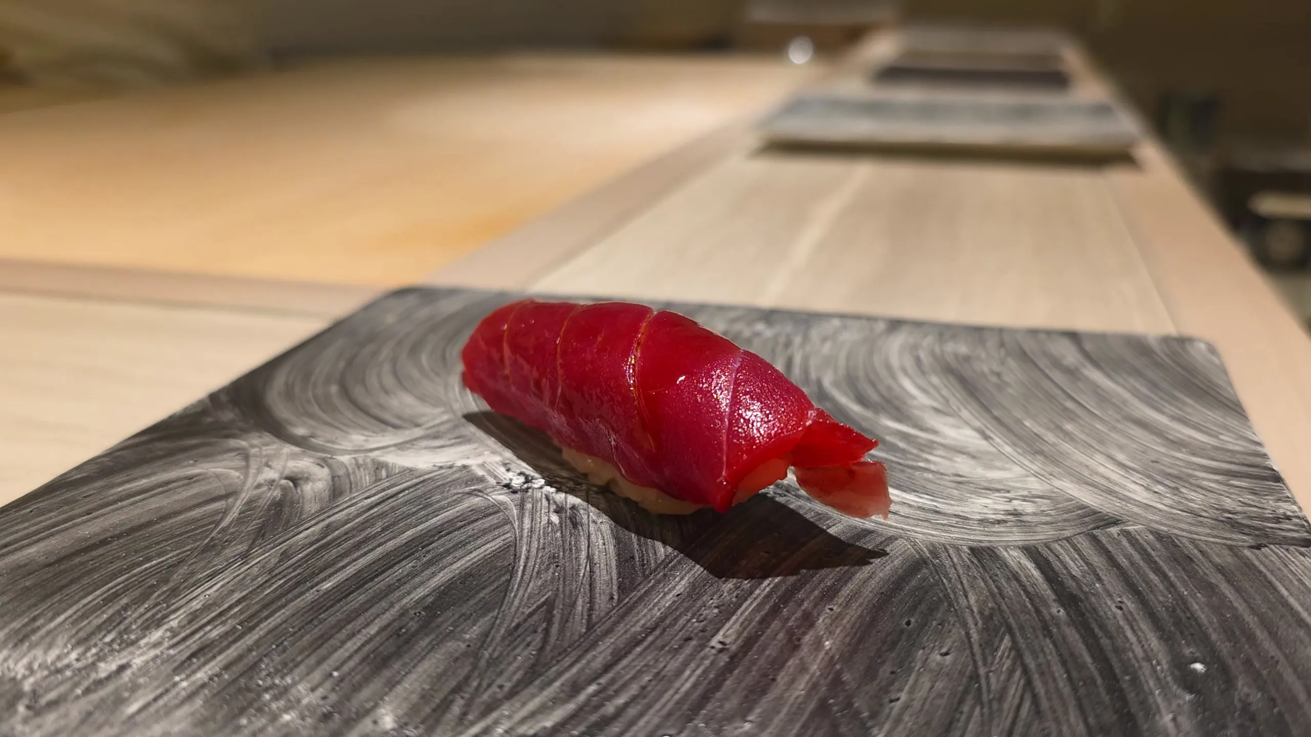 Akami nigiri on a slate plate at the Shimazu counter